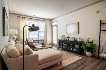 a living room with a couch and a table at Century New Holland, Gainesville